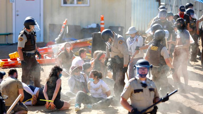 Police in riot gear arrest environmental activists at the Line 3 pipeline pumping station near the Itasca State Park, Minnesota on June 7, 2021.