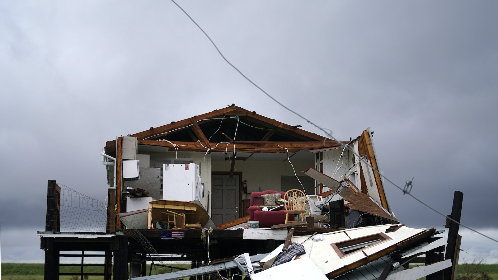 Storm clouds gather behind a home that was destroyed by Hurricane Ida, in Pointe-aux-Chenes, Louisiana.