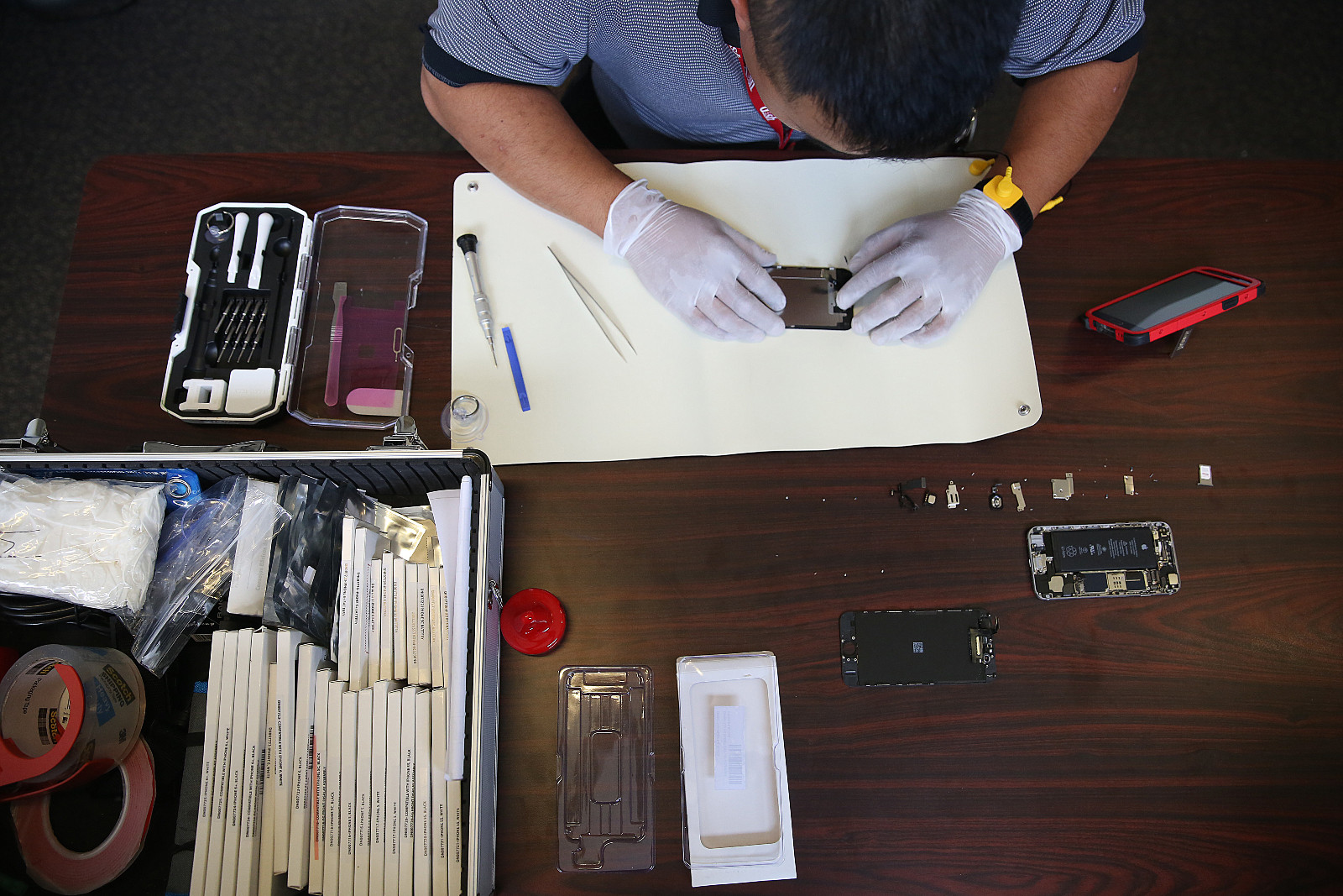 Dish employee Johnson Chuong takes apart an iPhone to fix a cracked screen in San Francisco, California, in 2016.