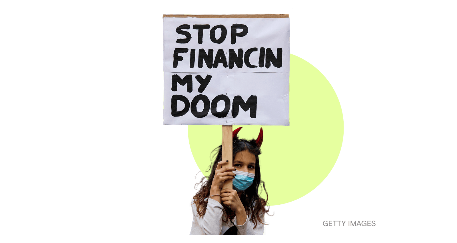 A girl holds a sign reading Stop Financing my Doom as people participate in a protest against the Royal Bank of Canadas investment in pipelines in Montreal, Quebec, Canada.