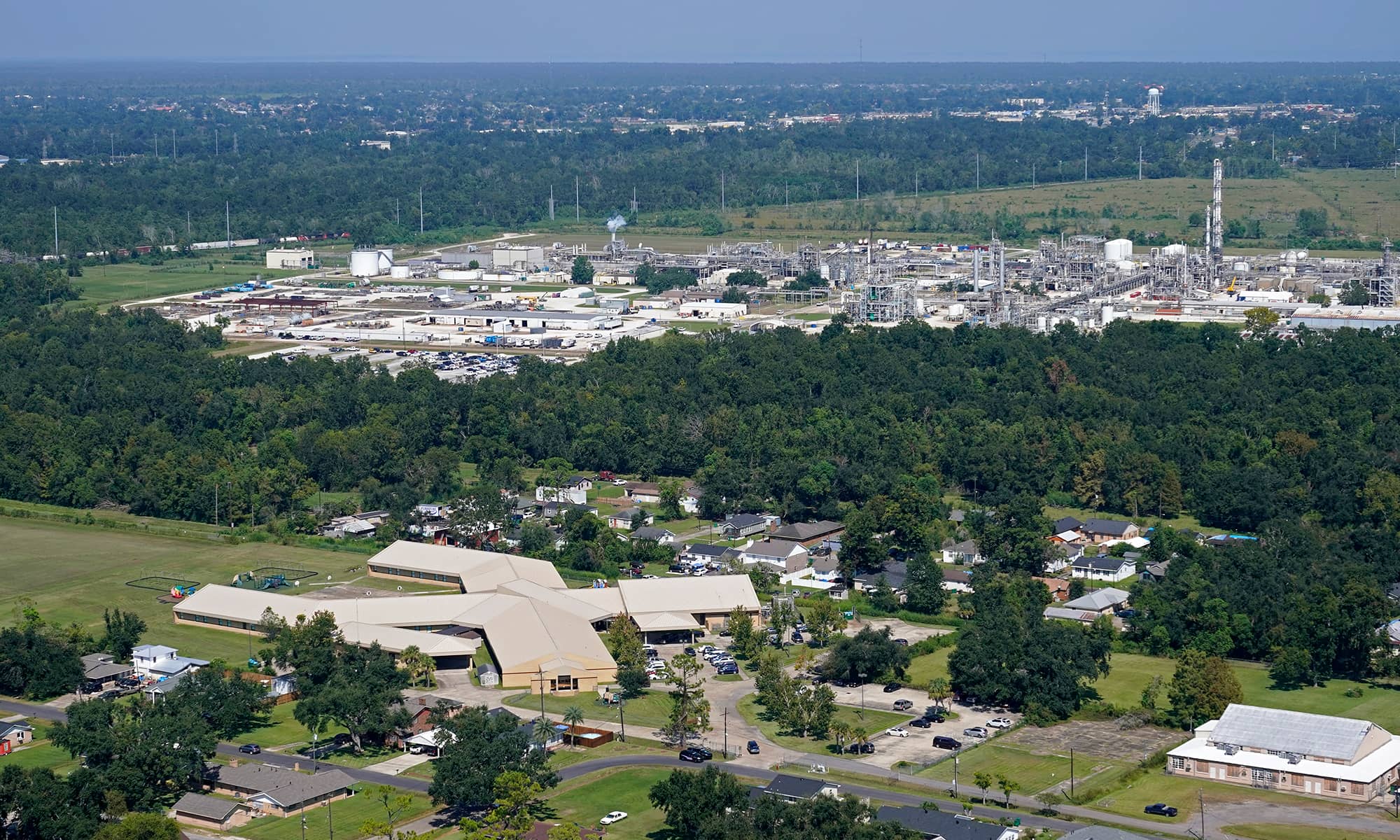 The Fifth Ward Elementary School and residential neighborhoods sit near the Denka Performance Elastomer Plant, back, in Reserve, La.