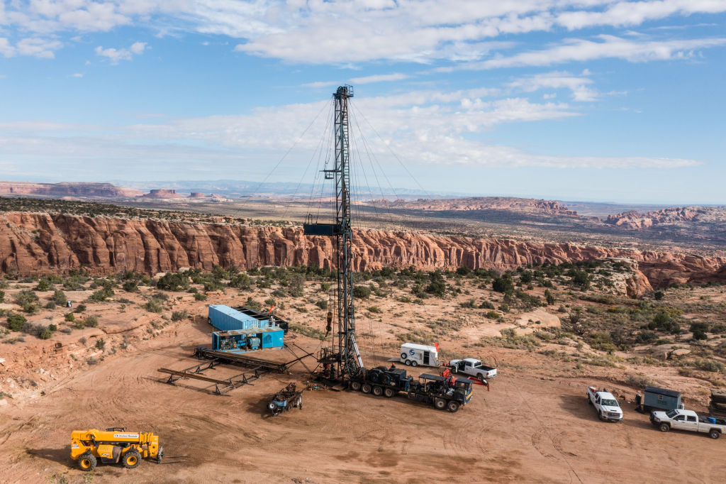 Oil rig with dramatic cliffs in the background