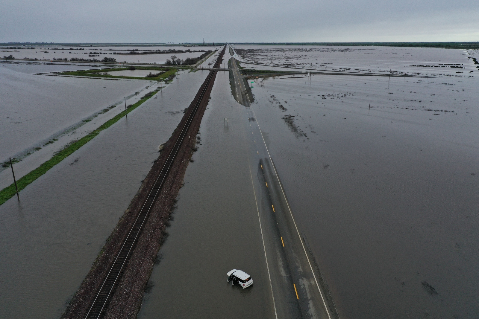 A vehicle surrounded by flood waters and flooded farmland near Allensworth, California. Much of the surrounding area has flooded as Tulare Lake reappears.
