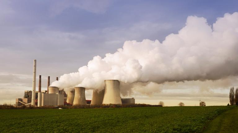 Emissions from a coal-fired power plant blow into the distance