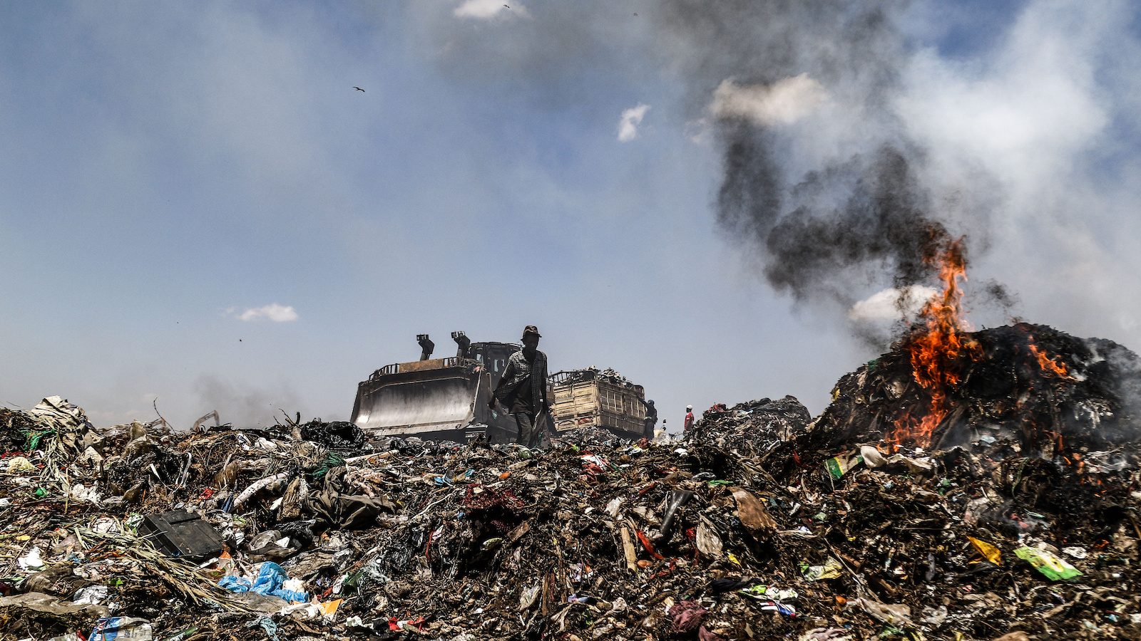 Trash burns at a dump residence