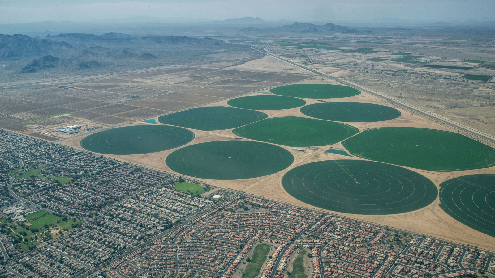 Golf resorts and urban housing developments in Arizona bordering farmlands on the Gila Indian Reservation.