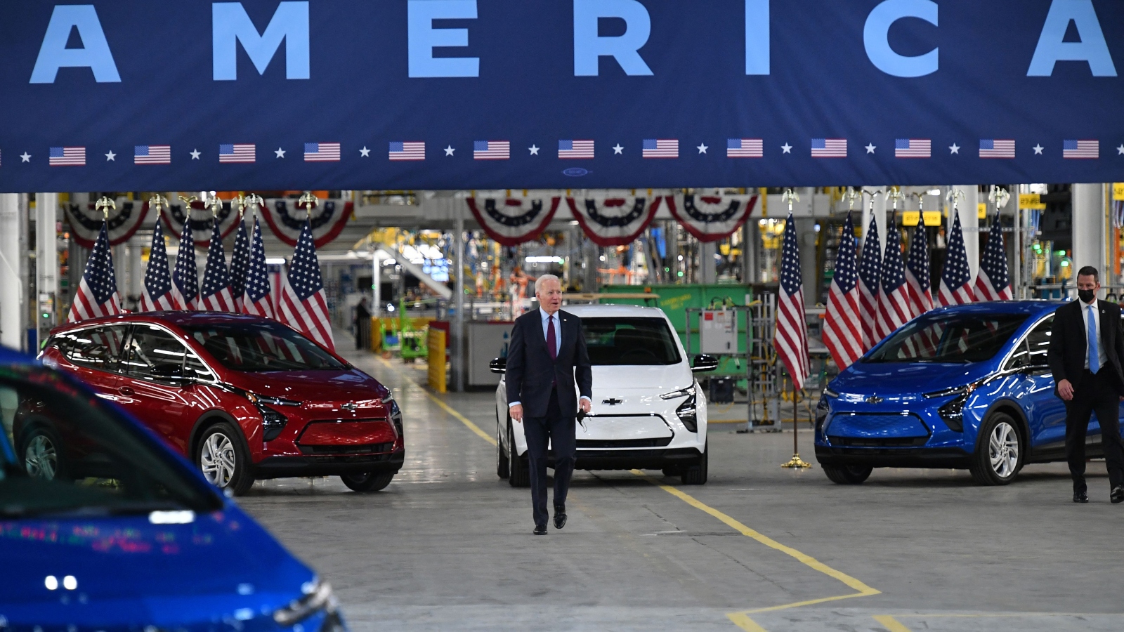 President Joe Biden walks near Chevy vehicles as he arrives to deliver remarks during a visit to a General Motors electric vehicle assembly plant in Detroit, Michigan.