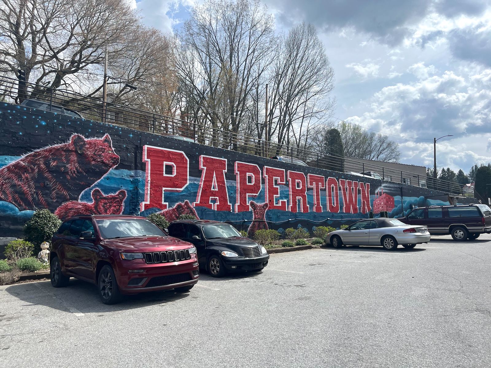 A large blue mural in downtown Canton, North Carolina shows two bears and the word "Papertown" in large red letters.