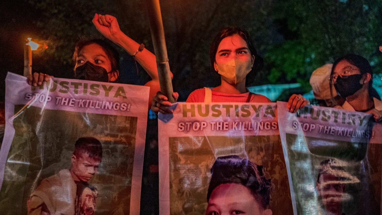 Activists hold up torches and portraits of slain indigenous peoples and environmental defenders during a rally on November 10, 2022 in Quezon city, Metro Manila, Philippines.