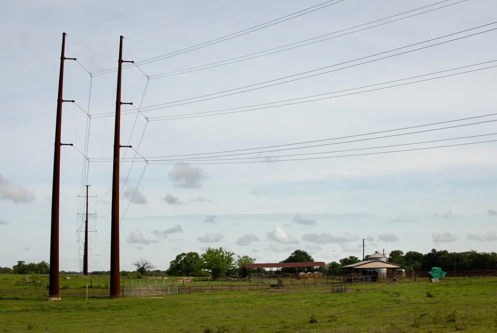 A field with electrical lines running across it.