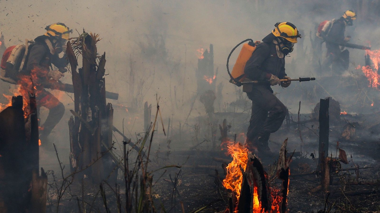 Firefighters and volunteers combat a fire on the Amazonia rainforest in Apui, Brazil, on September 21, 2022.
