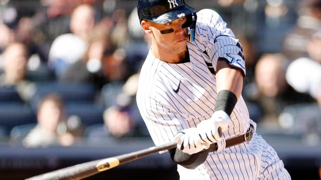 A man swings his bat at home plate in a baseball game.