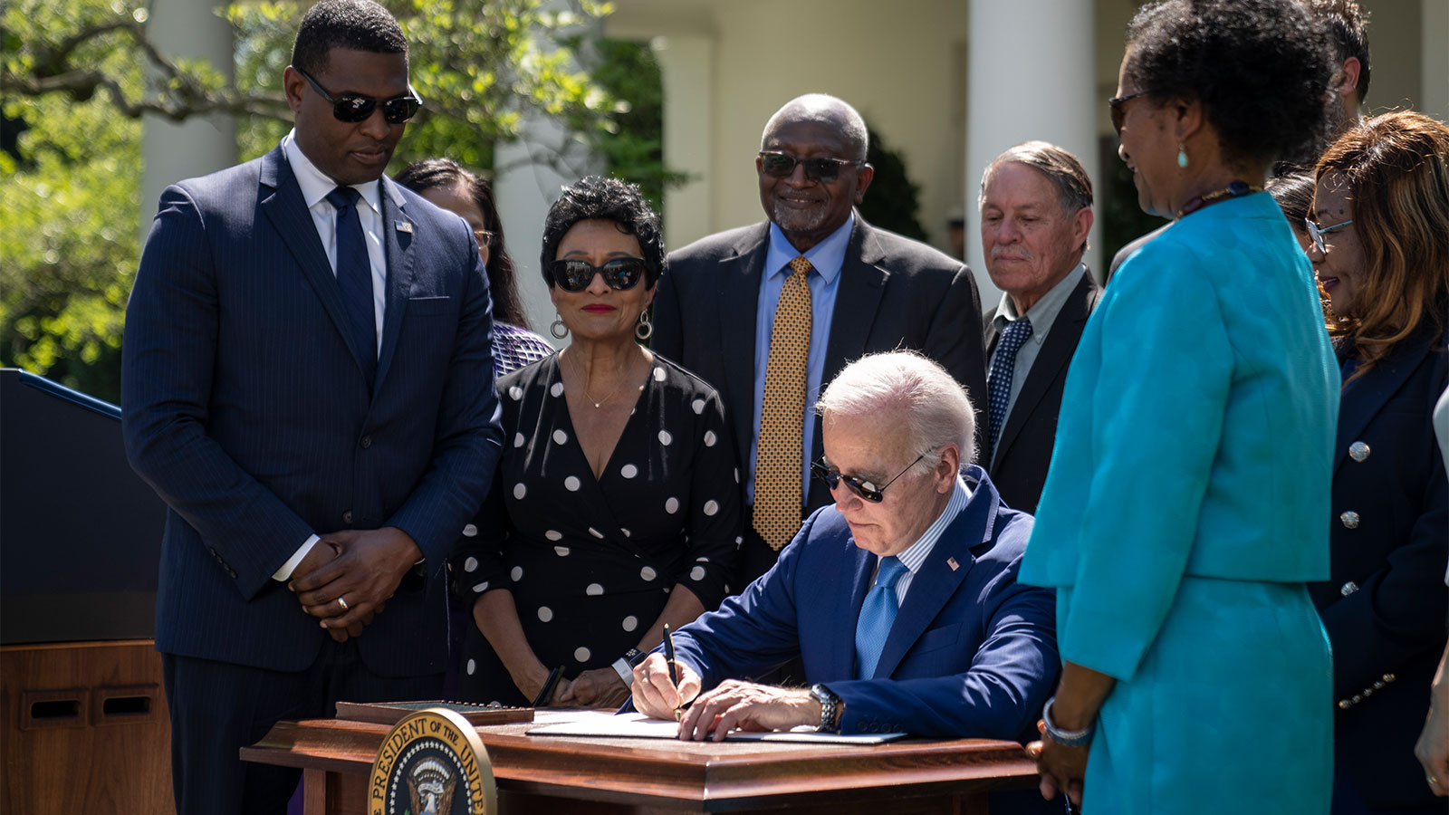 U.S. President Joe Biden is surrounded by environmental justice advocates and U.S. EPA Administrator Michael Regan as he signs an executive order addressing environmental justice issues in the Rose Garden of the White House.