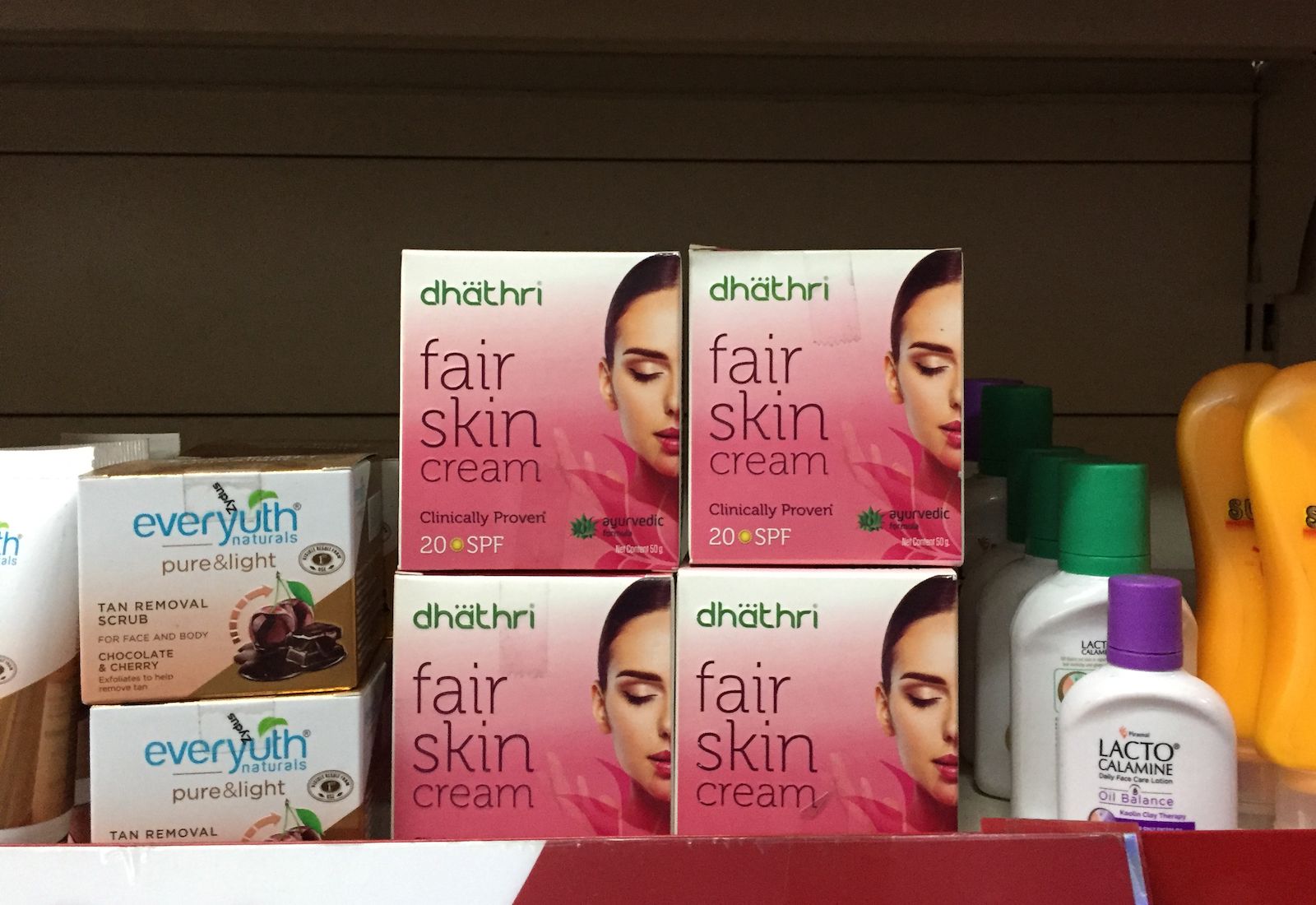Boxes of "fair skin cream" on a store shelf