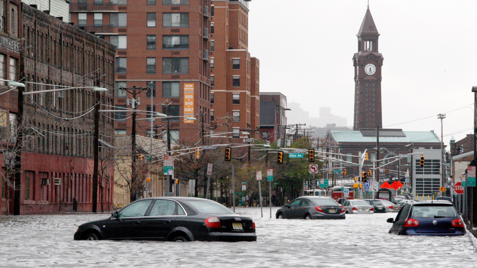 Photo of cars in a highly flooded street in New Jersey.