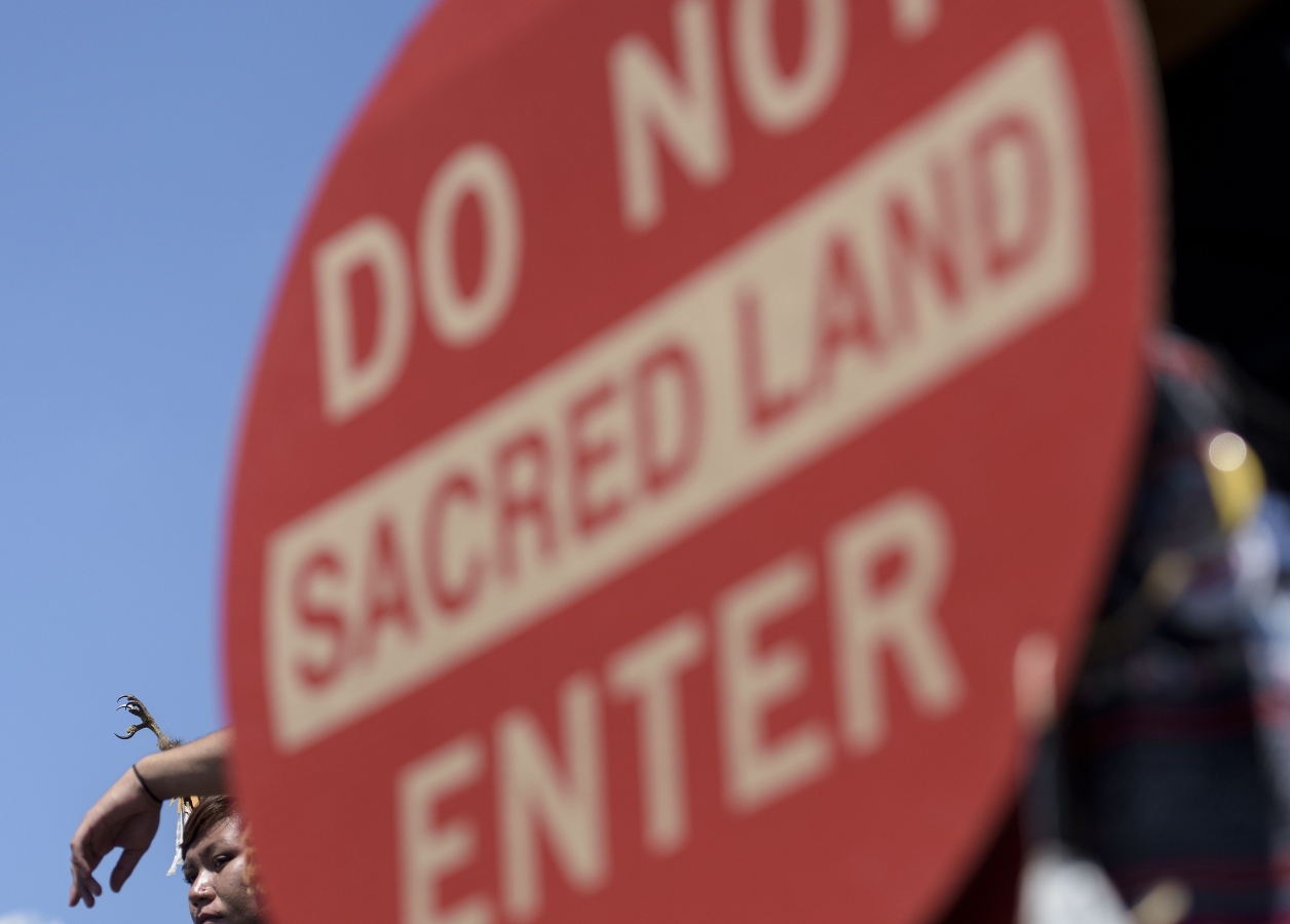 A protest sign read "Do Not enter Sacred Land"