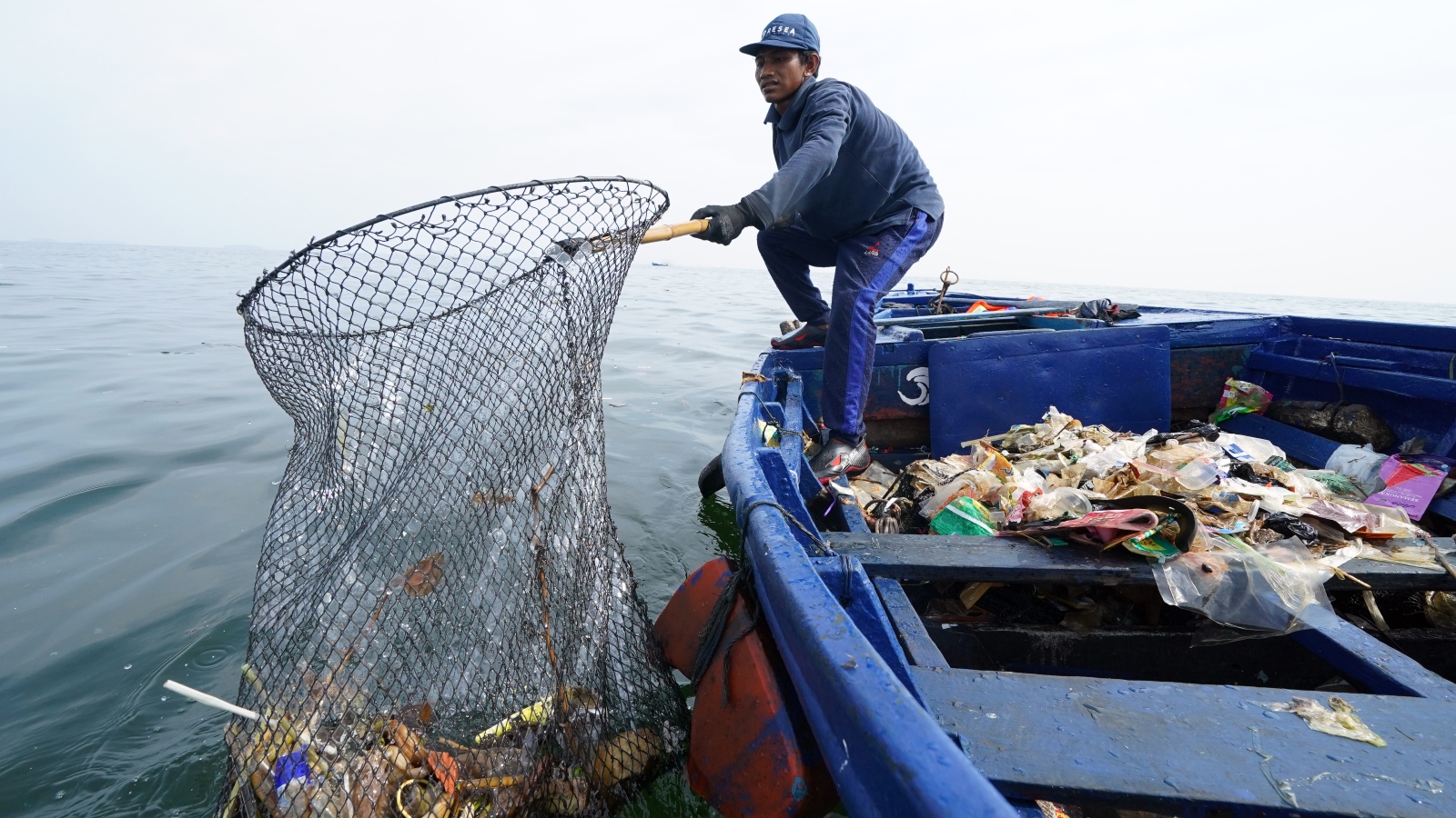 A worker from the Danish firm ReSea Project collecting plastic waste in Indonesia, home to some of the world's most polluted waters.