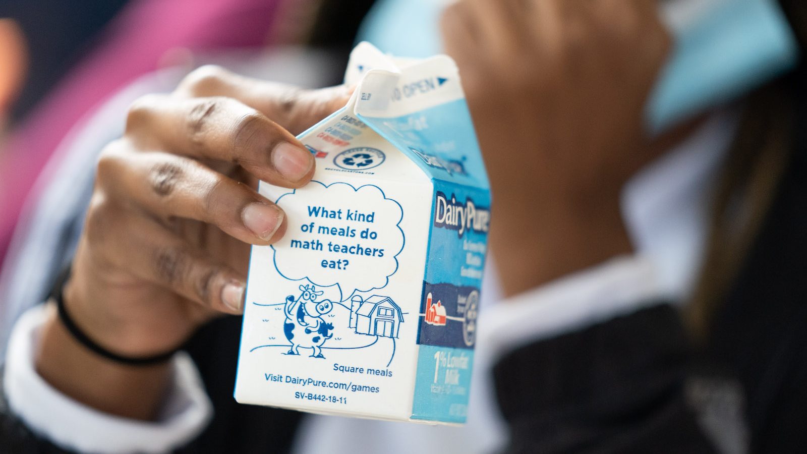 A student holds a milk carton