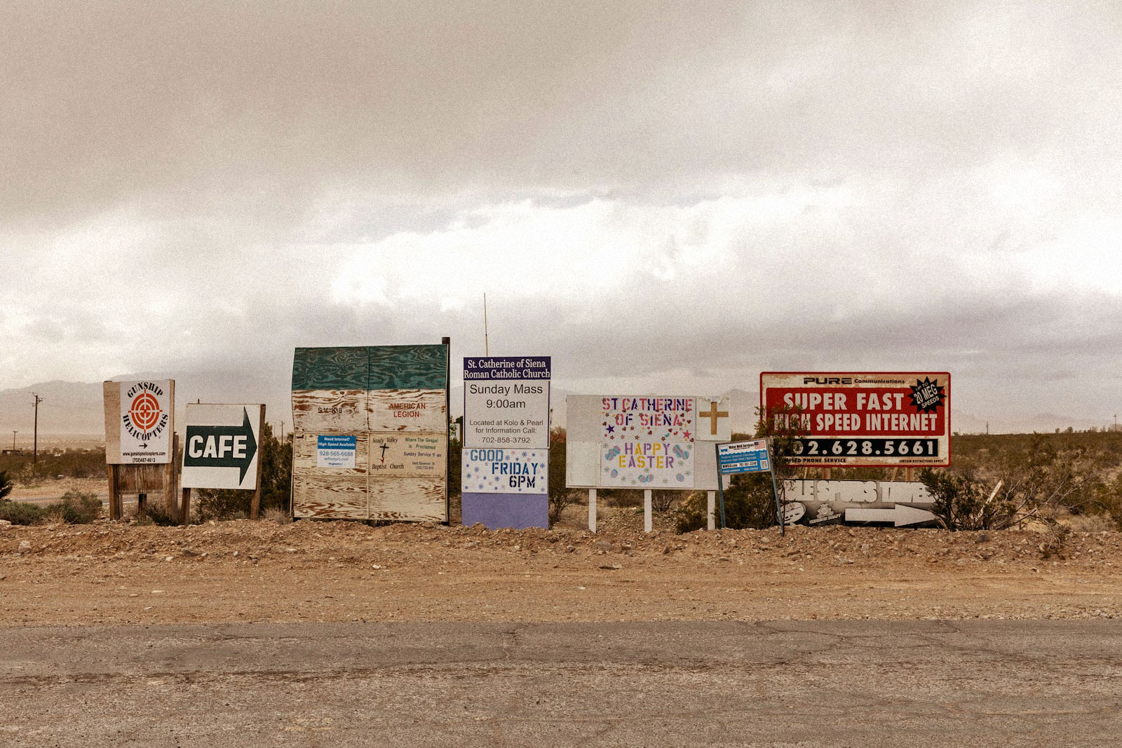 a line of signs on a dry stretch of land