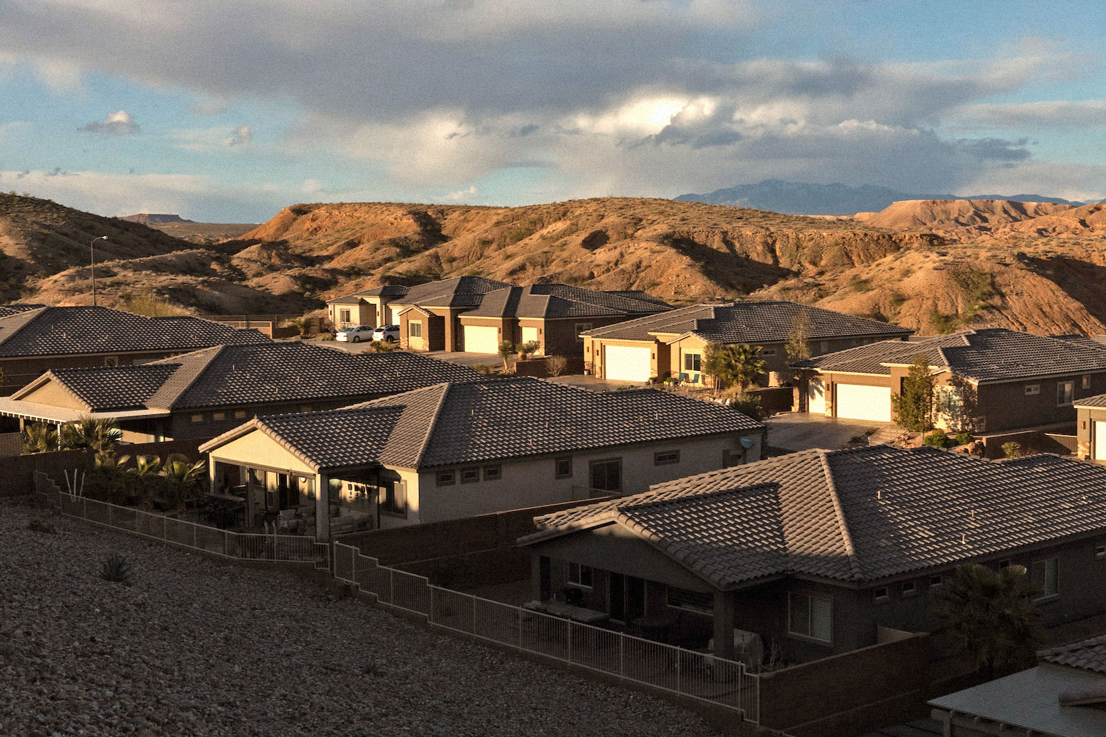 shadows creep over rows of desert housing