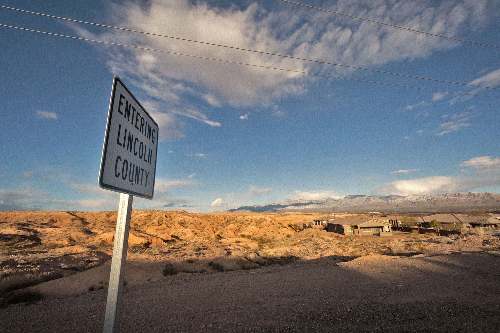 a sign says lincoln county hear a desert highway