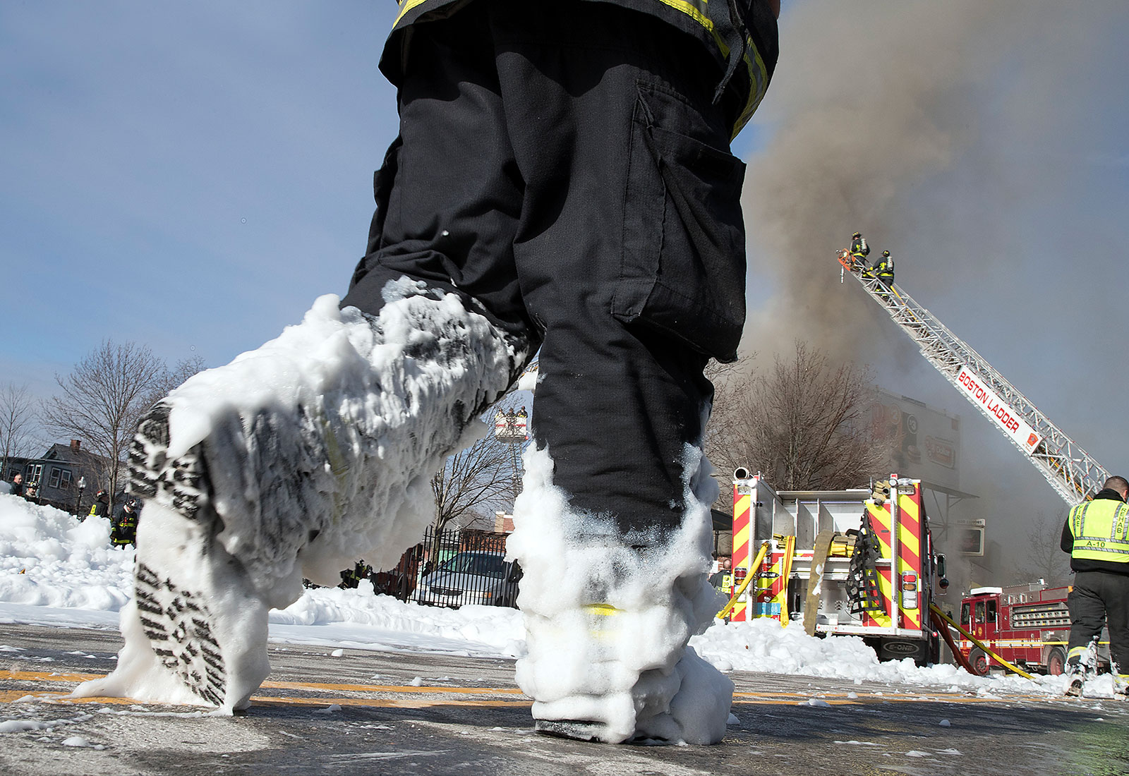 Firefighter walking with foam-covered boots