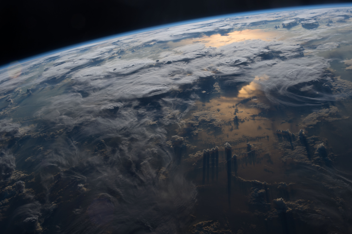 An aerial view of the earth and the clouds covering it.