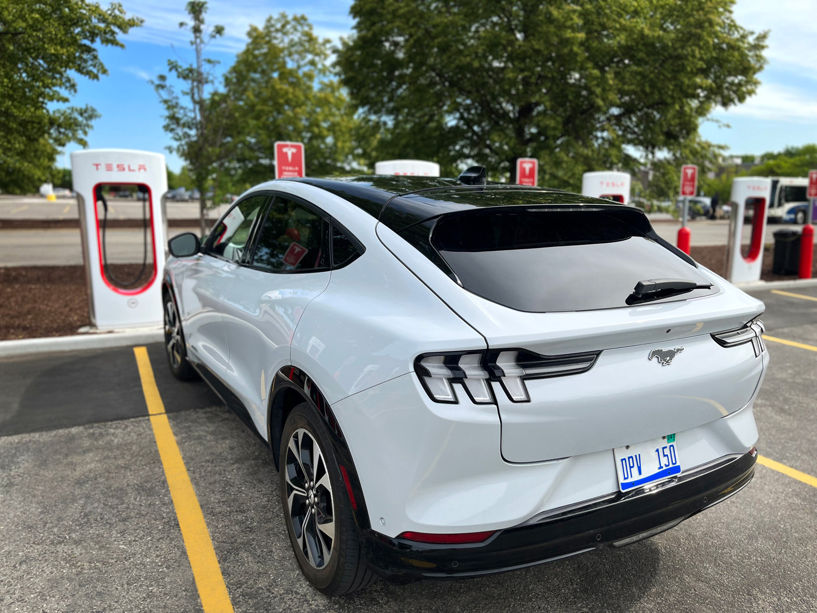 Ford Mustang Mach-E at Tesla Supercharger station