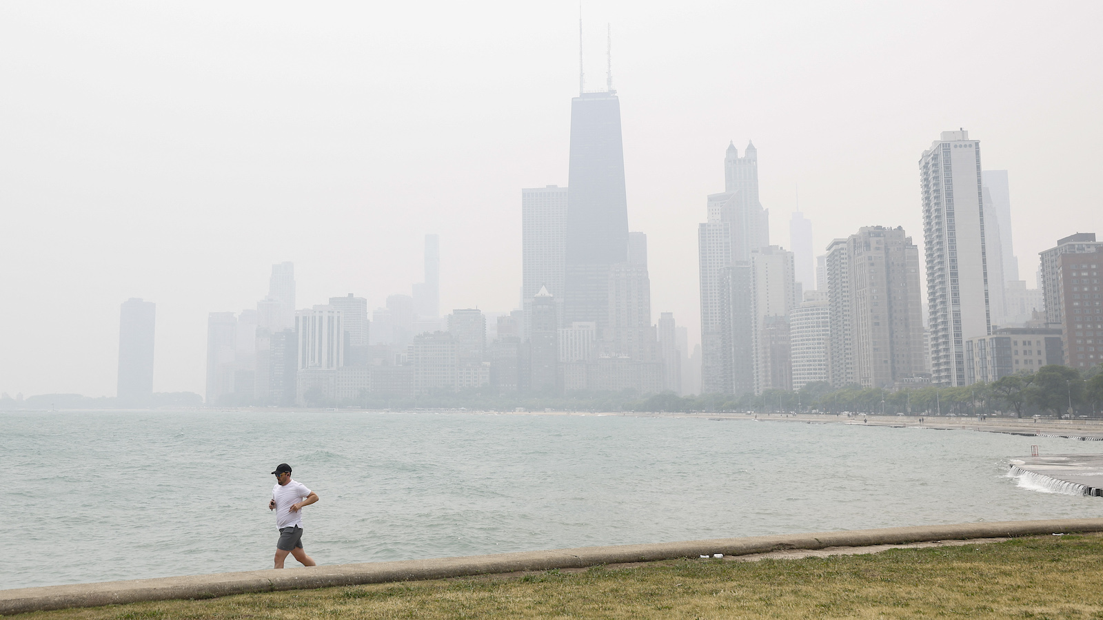 A runner with smoky Chicago skyline in background