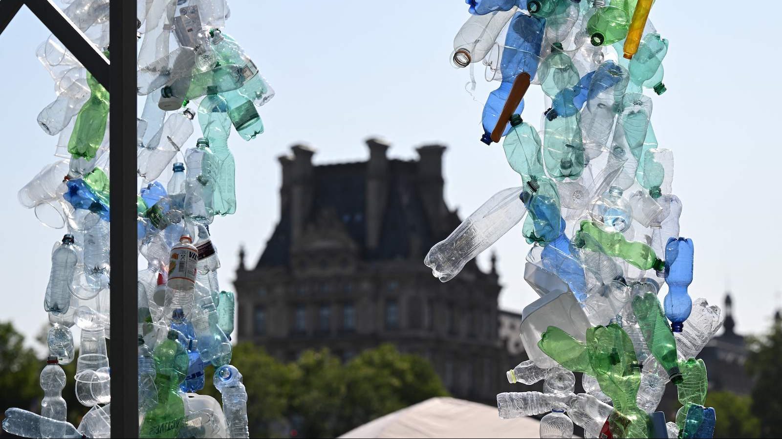 Plastic bottles in a sculpture, with building in background