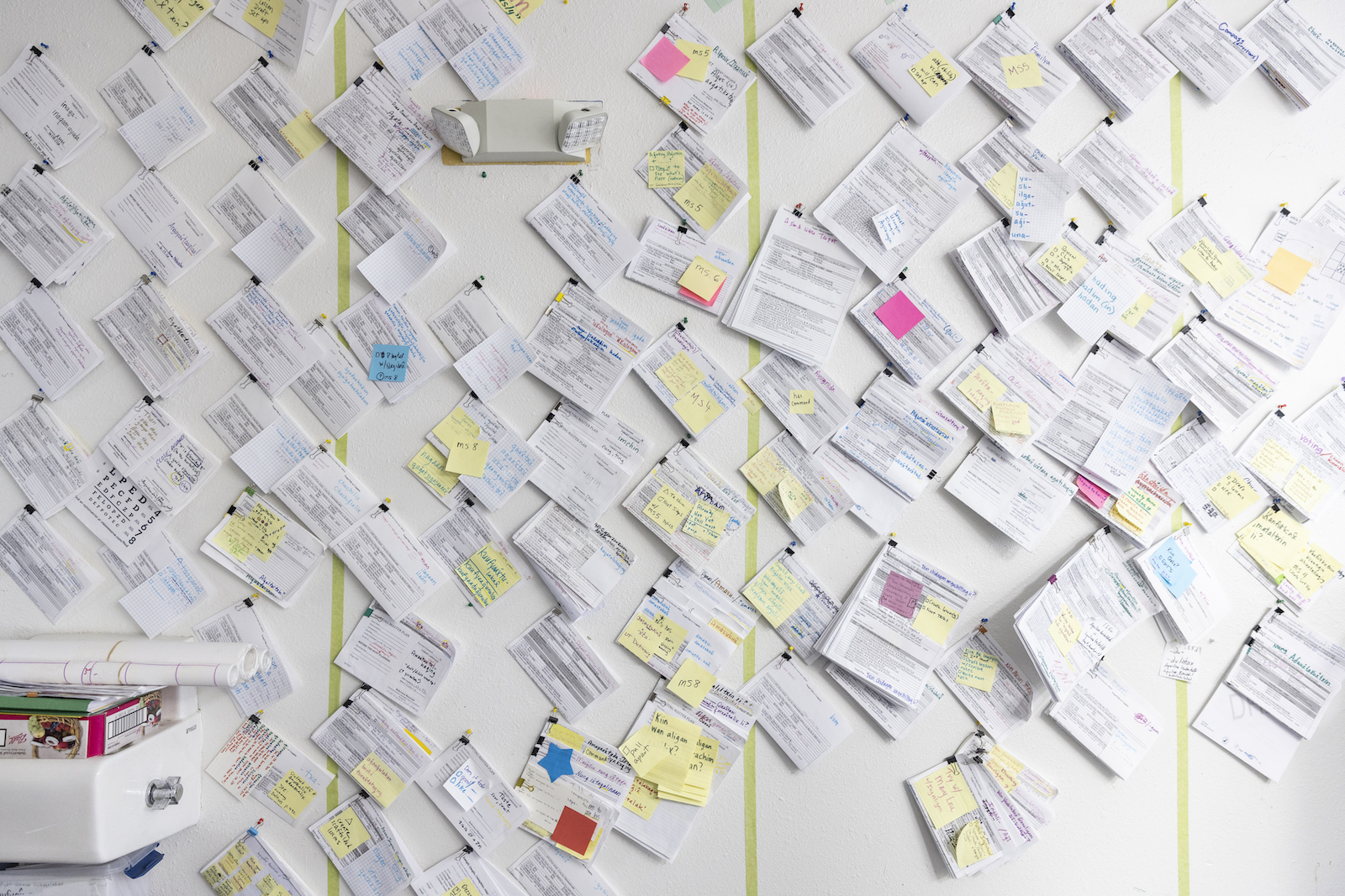 A classroom wall covered in papers and post-it notes