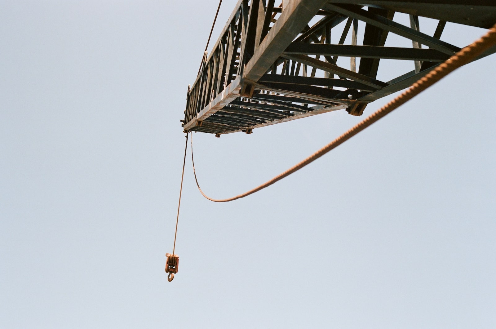 An abandoned crane stands near old fishing equipment along the shores of Cameron, Louisiana.