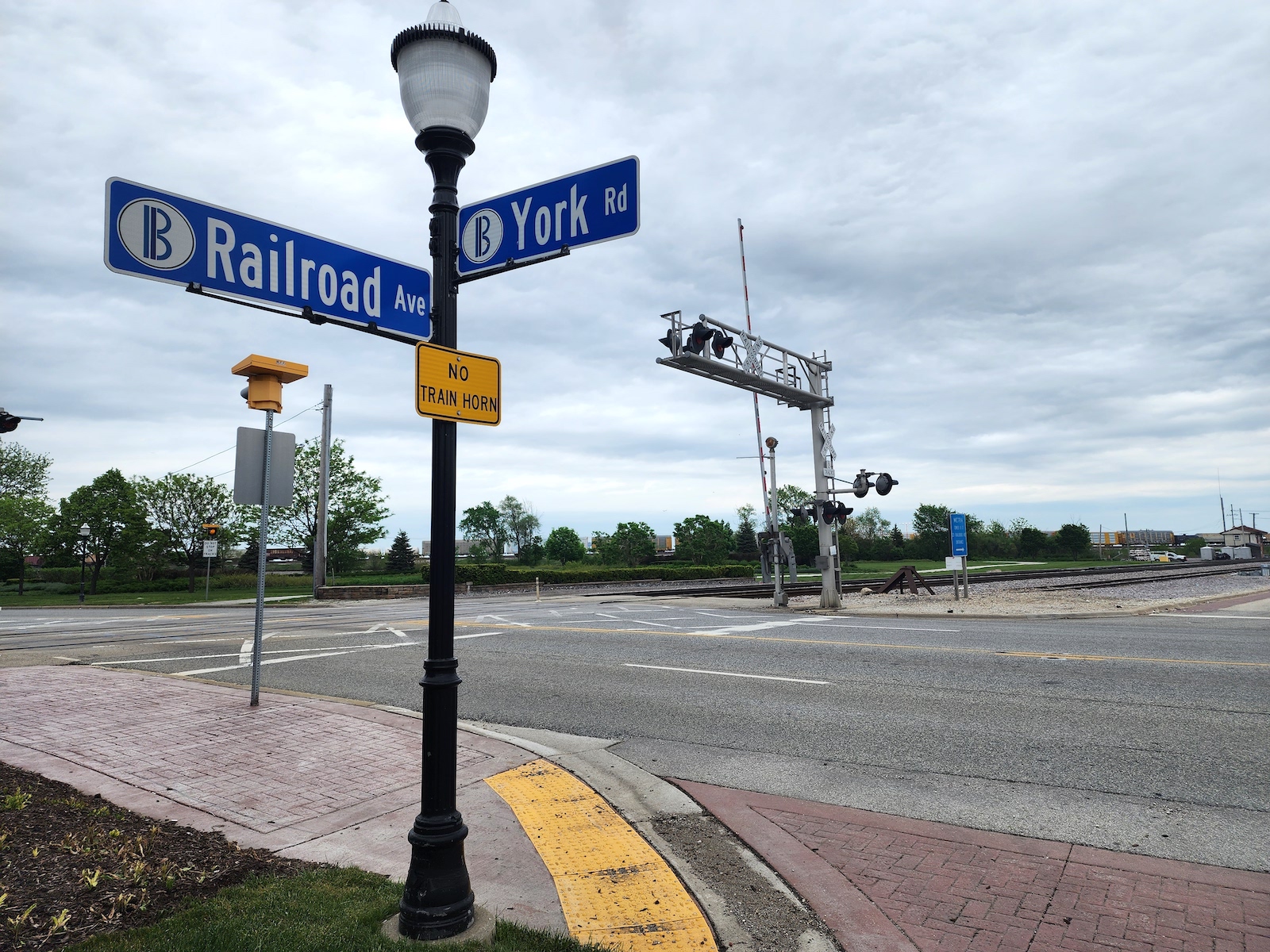 A sign marks the intersection of Railroad Ave and York Road in Bensenville, Illinois.