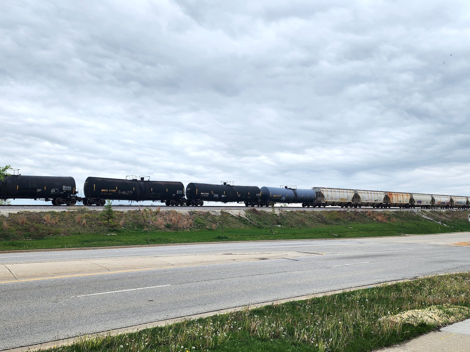 A long train carrying several tankers runs through Camanche, Iowa.