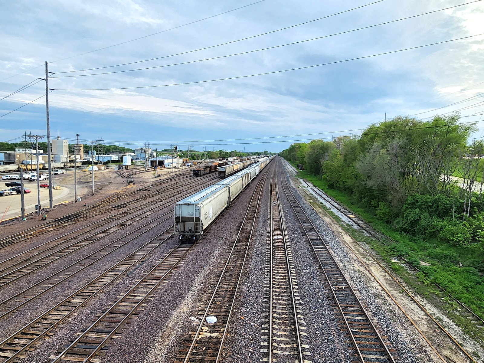 A train runs along a mult-track section of railroad