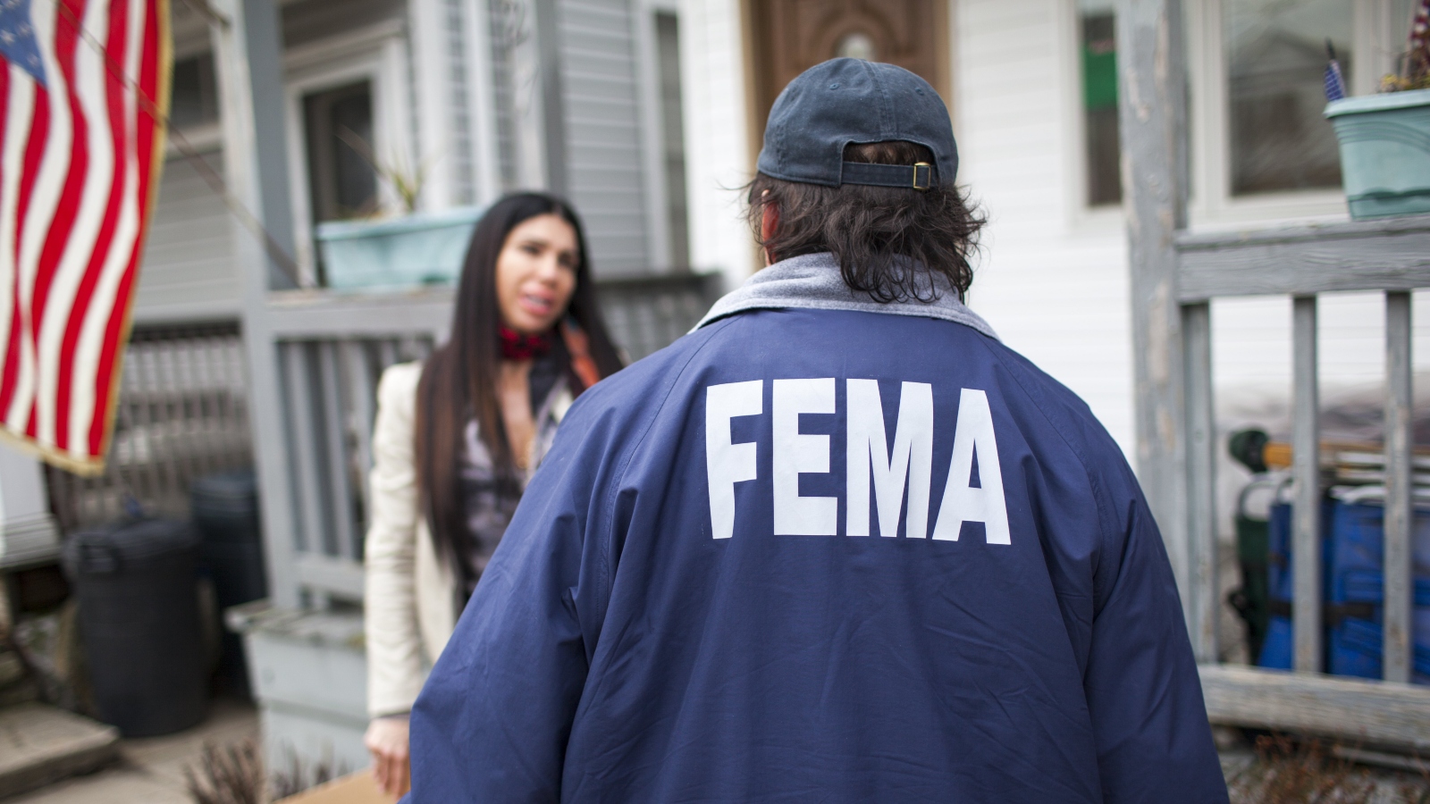 A FEMA representative surveys a woman about heat and power availability in a New York City neighborhood damaged during Hurricane Sandy.