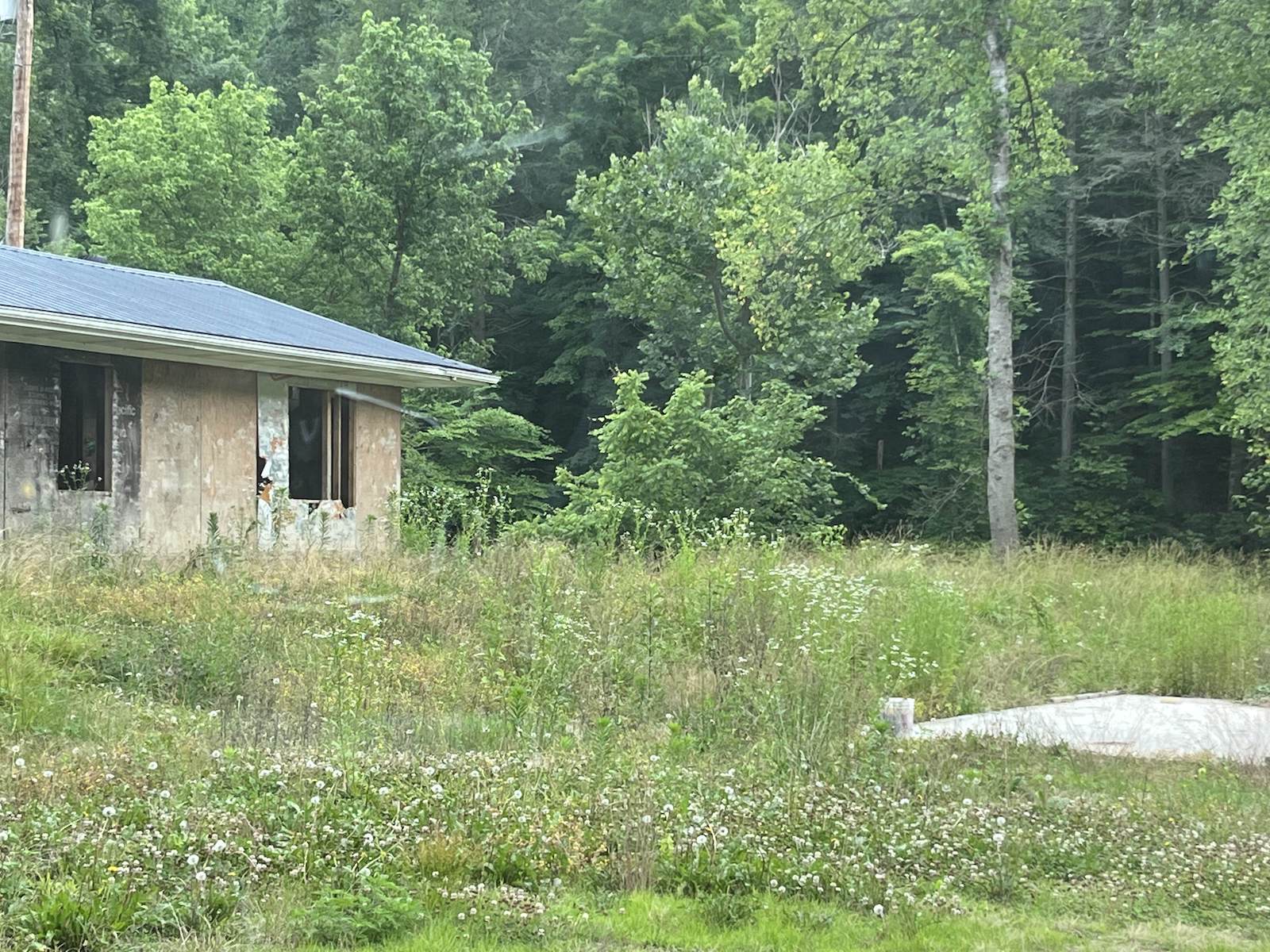 A flood-damaged building sits vacant in Lost Creek, Kentucky