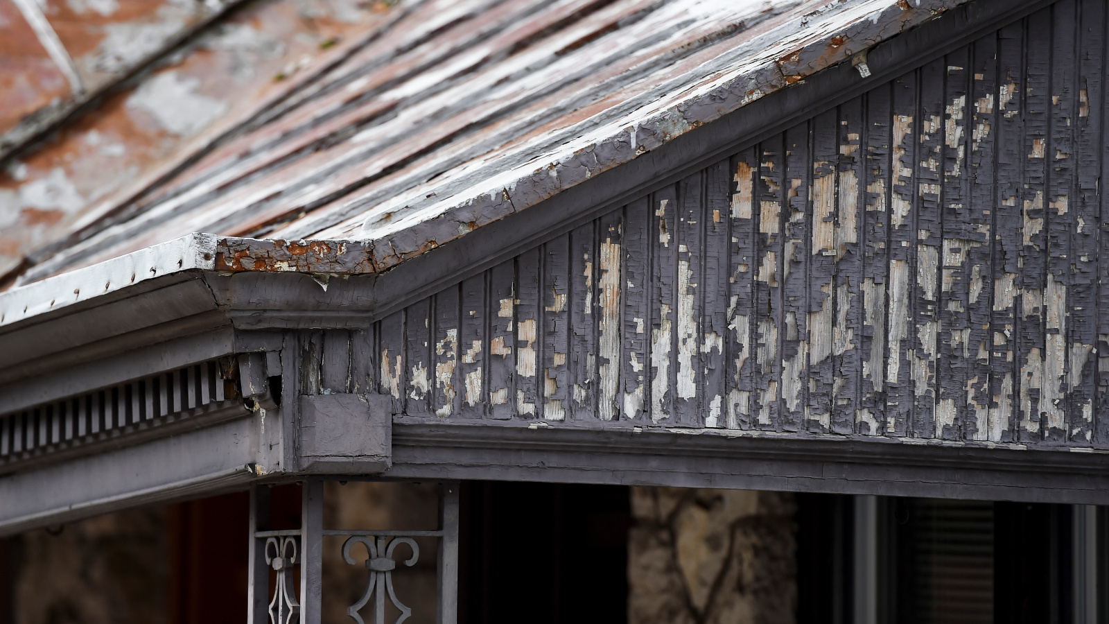 Photo of peeling paint on the porch of an older home