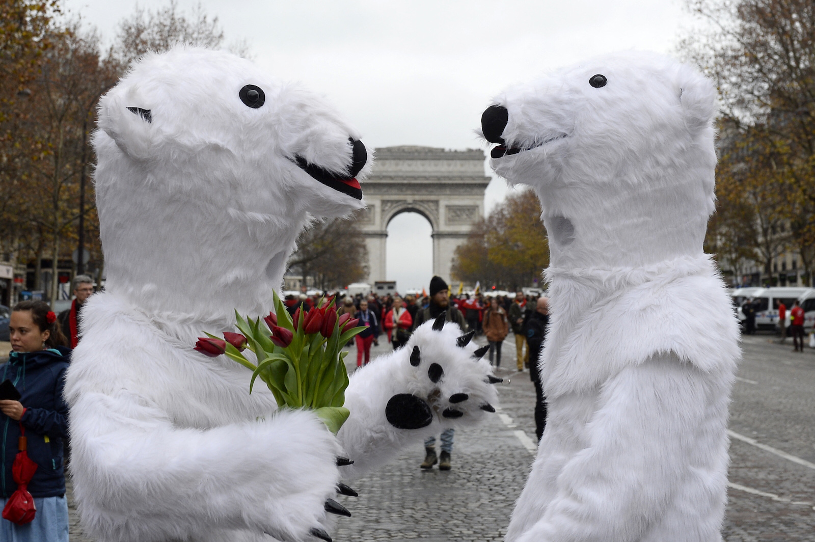 two people in polar bear suits in front of an arc