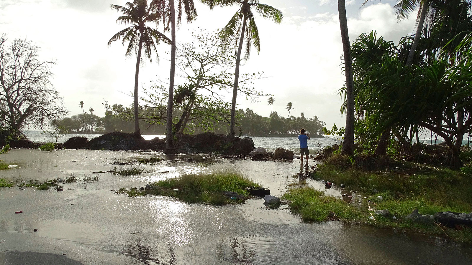 A resident walks through tidal water in the Marshall Islands