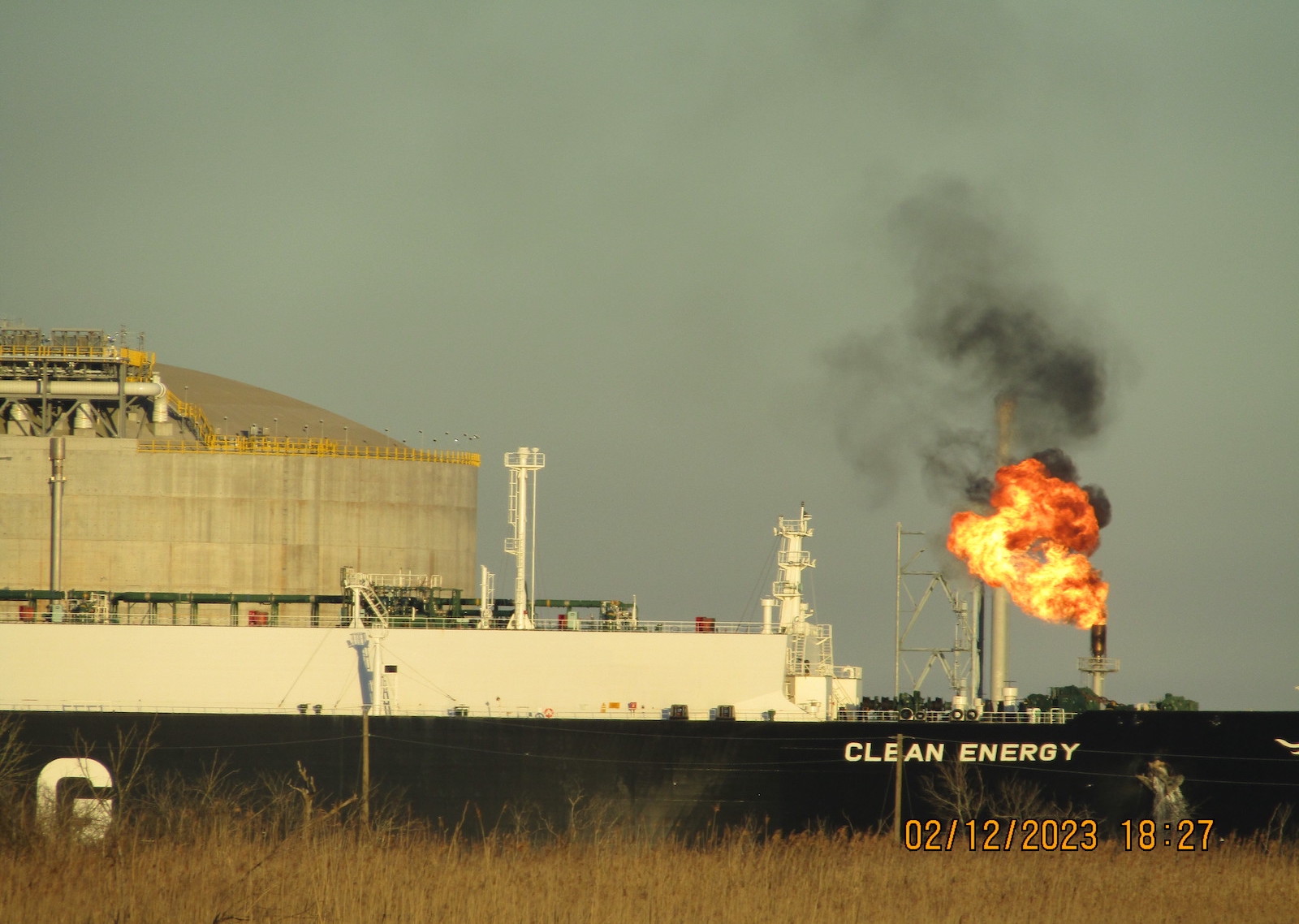 a giant fireball comes out of a stack near a ship called clean energy