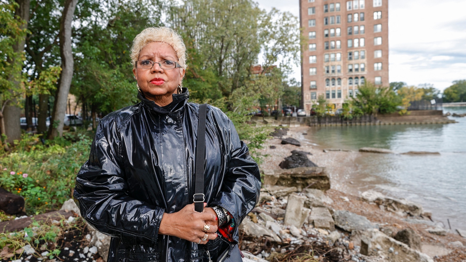 Jera Slaughter, a resident of South Shore in Chicago, looks at the camera as the lake inches closer to her building in the background. She's been central in the fight to protect her neighborhood in Chicago from rising lakewaters.