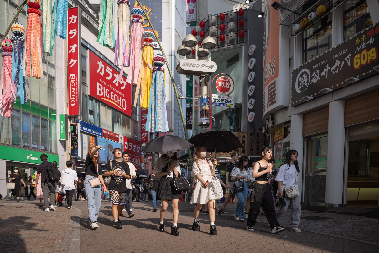 Pedestrians protect themselves from the sunshine with umbrellas on a day where the temperatures reached over 96 degrees Fahrenheit in Tokyo.