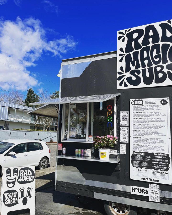 Exterior view of a food truck, with sign reading "Rad Magic Subs"