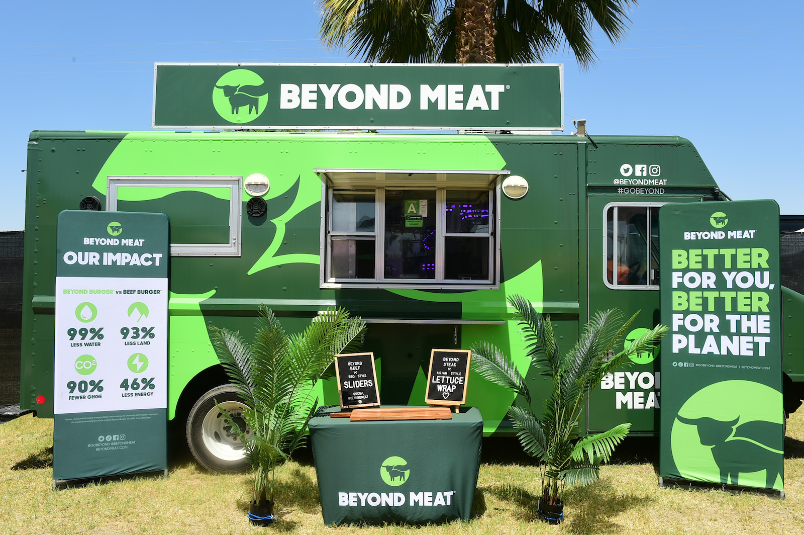 a green food truck with a sign that says beyond meat