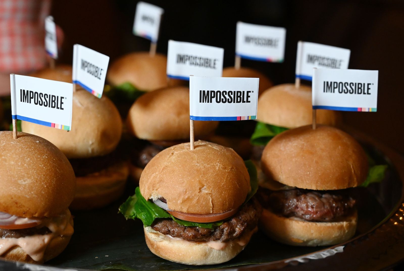 a bunch of tiny burgers with little flags saying impossible