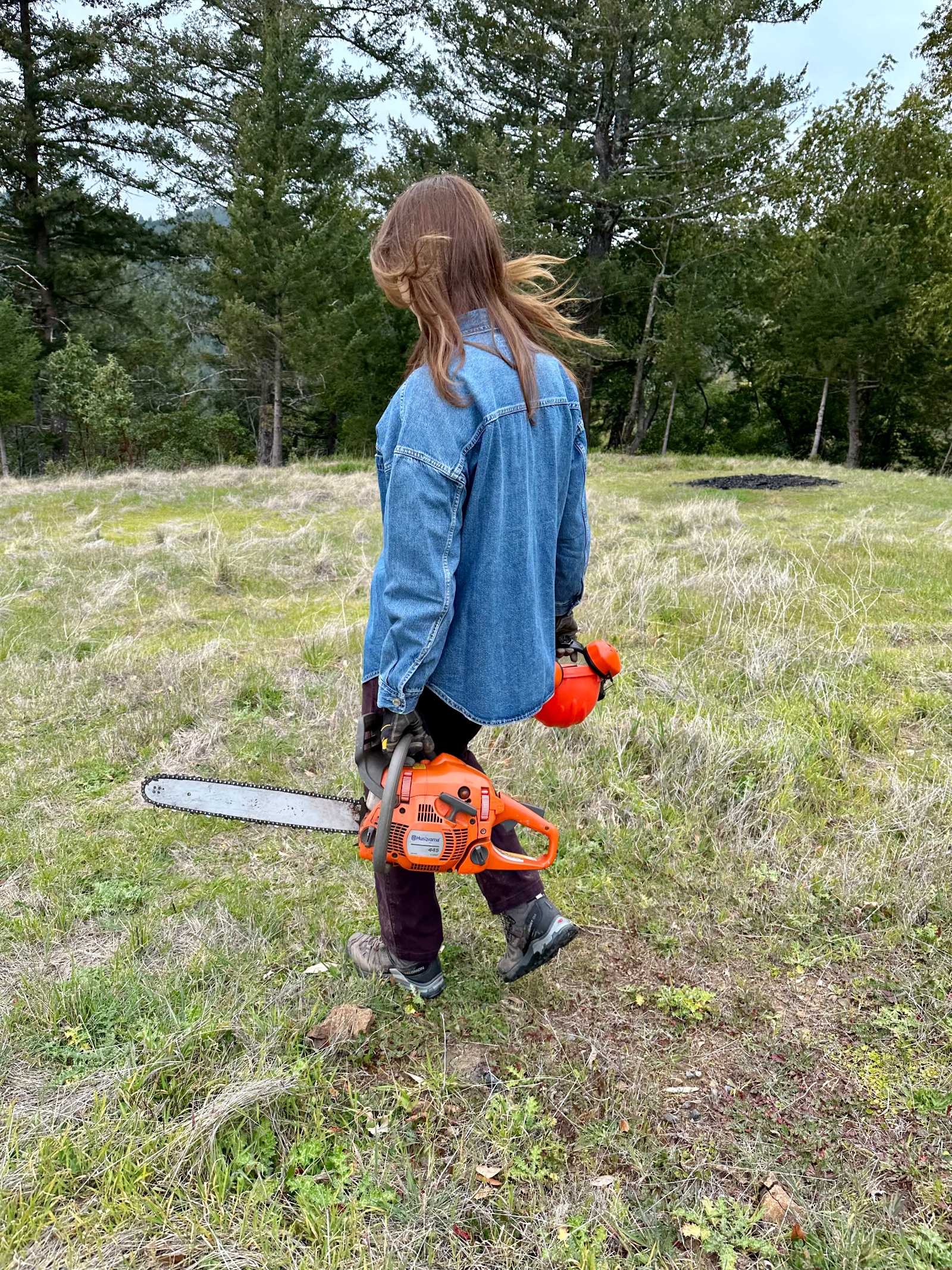 Author walking with a chainsaw