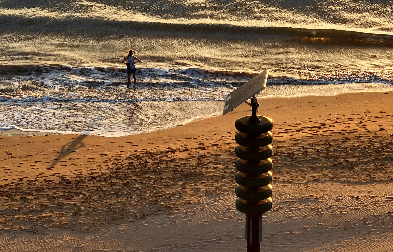 a siren on a beach near a woman in the water