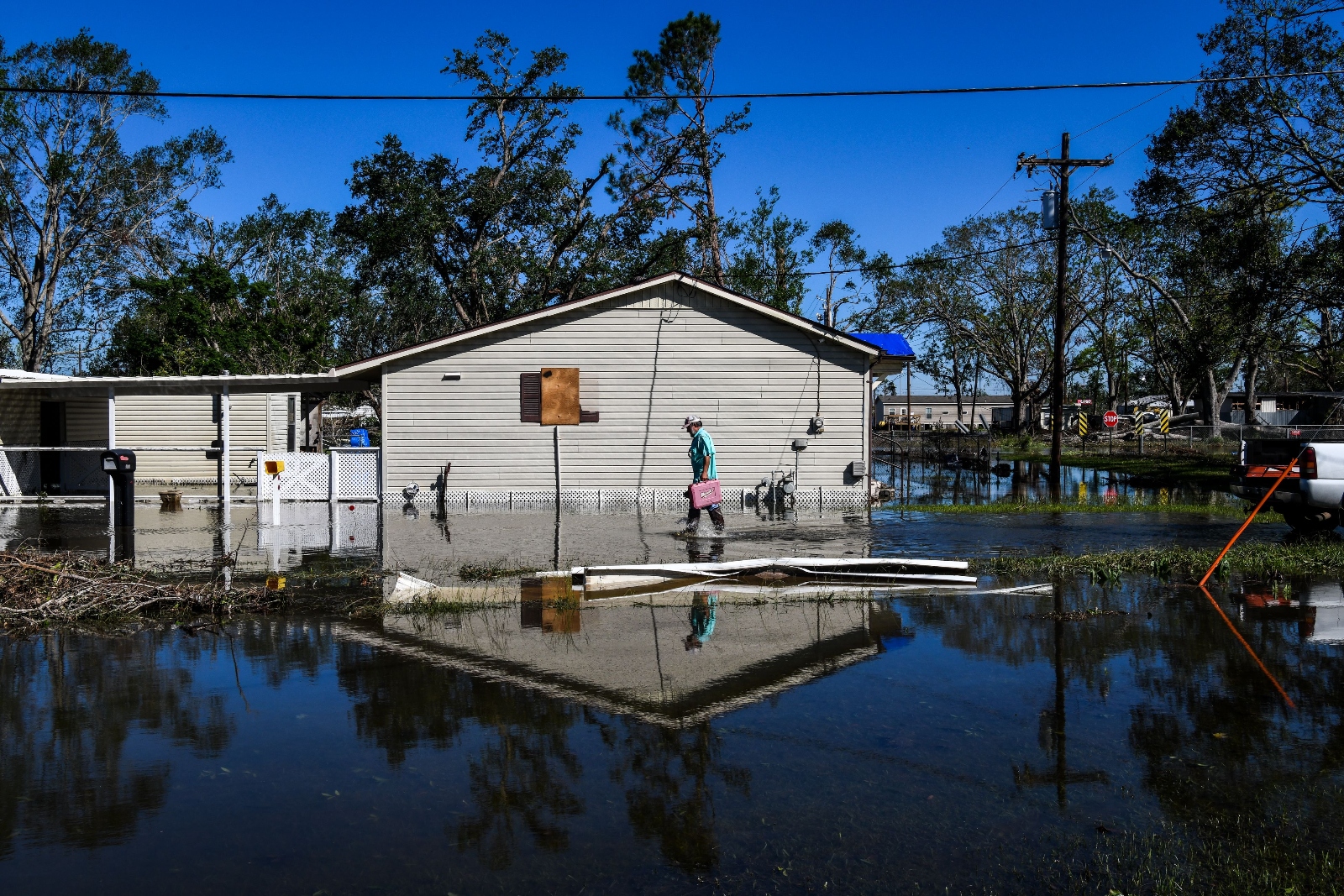 Daniel Schexnayder walks in flooded water outside his house after Hurricane Delta passed through the area on October 10, 2020 near Lake Charles, Louisiana.