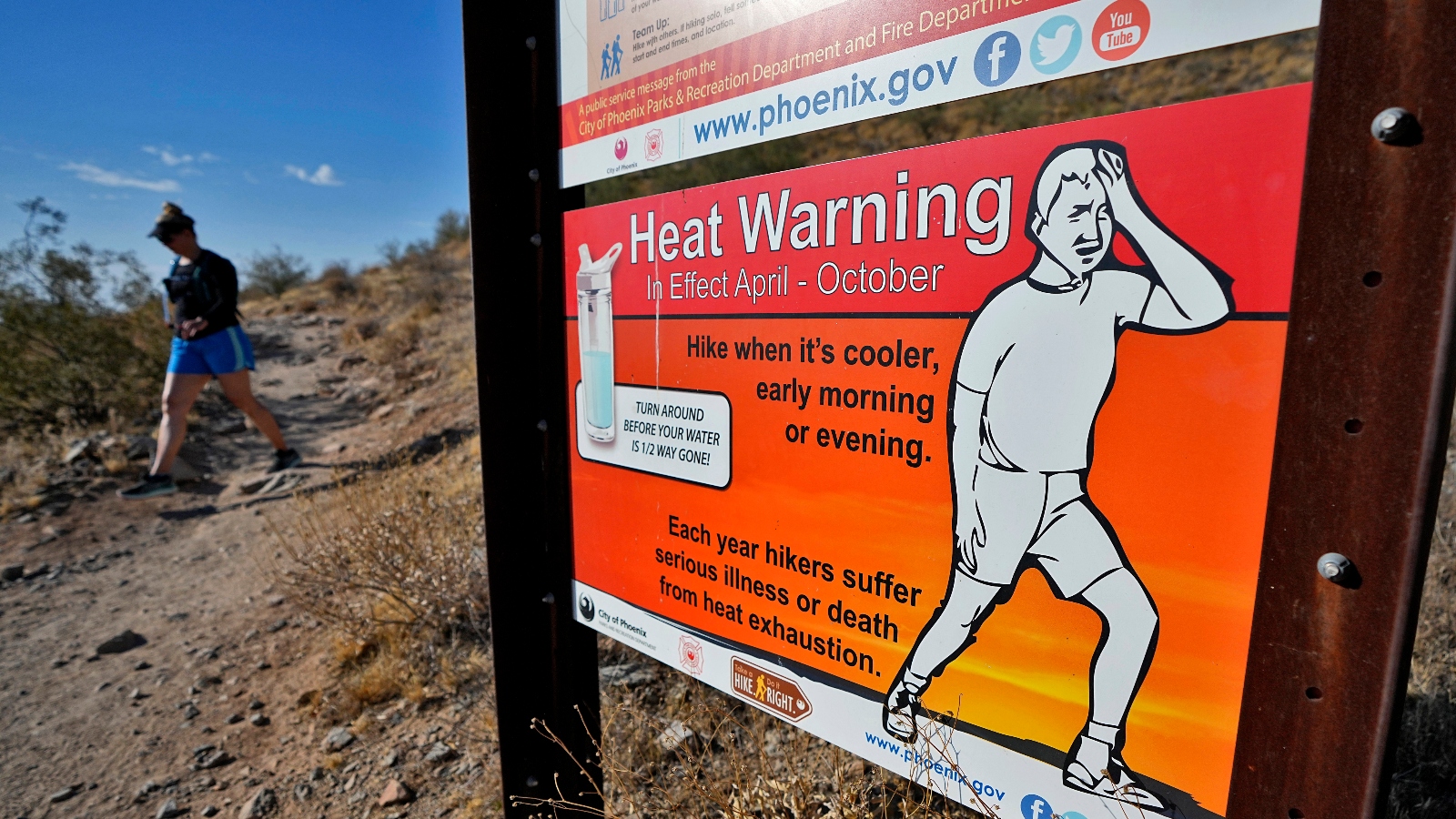 A hiker finishes her hike early to beat high temperatures on Monday, July 10, 2023 in Phoenix. The city experienced 110 degree F temperatures for a month straight this summer.